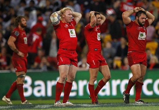 Queensland Reds&#039; players react following the defeat against the Sharks of South Africa, in Brisbane, on July 21, 2012