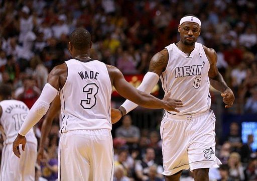 Dwyane Wade (L) and LeBron James of the Miami Heat high-five during a game on February 10, 2013
