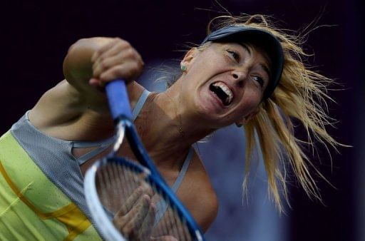 Maria Sharapova of Russia serves to Samantha Stosur of Australia on February 15, 2013 in Doha