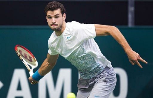 Grigor Dimitrov of Bulgaria returns the ball to Marcos Baghdatis from Cyprus in Rotterdam on February 15, 2013