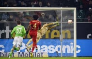 Bayern Munich's goalkeeper Manuel Neuer (R) saves a free kick in Wolfsburg, northern Germany, on February 15, 2013