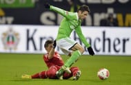 Wolfsburg's Christian Traesch (R) and Bayern Munich's Bastian Schweinsteiger fight for the ball on February 15, 2013