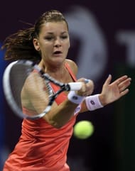Agnieszka Radwanska of Poland returns the ball to Belarus Victoria Azarenka on February 16, 2013 in Doha