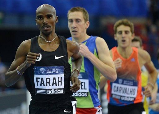 Mo Farah of Great Britain (L) leads during the mens 3000 metres in Birmingham, central England on February 16, 2013