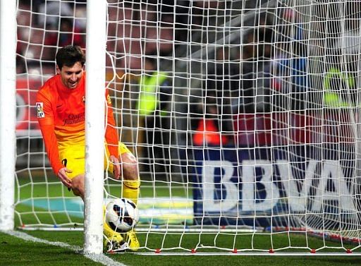Barcelona&#039;s forward Lionel Messi celebrates after scoring in Granada on February 16, 2013
