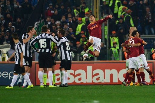 AS Roma players celebrates at the end of their Italian Serie A football match against Juventus on February 16, 2013
