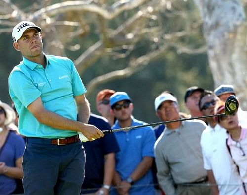 Bill Haas watches his tee shot on the 18th hole on February 16, 2013 in Pacific Palisades, California