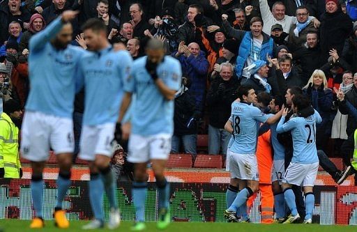 Manchester City&#039;s players celebrate scoring a goal against Stoke City, in Stoke-on-Trent, on January 26, 2013