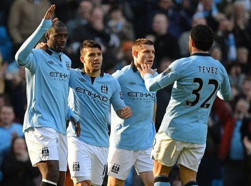 Yaya Toure (left) celebrates with team mates after scoring the opener against Leeds in Manchester on February 17, 2013