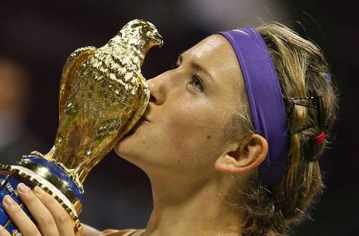 Victoria Azarenka poses with the trophy in Doha on February 17, 2013