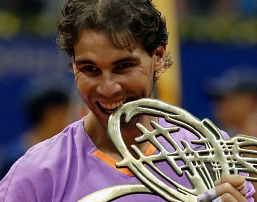 Spanish tennis player Rafael Nadal celebrates with the trophy in Sao Paulo, Brazil, on February 17, 2013