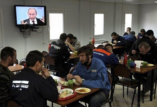This picture taken on December 15, 2011 shows labourers at one of the Sochi Olympic venues enjoying a stop for lunch