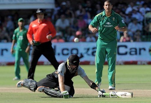 New Zealand batsman Robert Nicol makes a dive as Rory Kleinveldt (right) looks on in Port Elizabeth on December 26, 2012