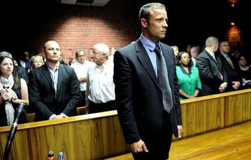 Oscar Pistorius (C) appears on February 19, 2013 at the Magistrate Court in Pretoria