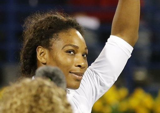 US tennis player Serena Williams waves to the audience at the WTA Dubai Open on February 20, 2013