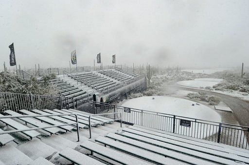 Snow covers the first hole tee and the grandstands as play was suspended, on February 20, 2013