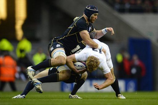 Euan Murray (L) tackles England&#039;s Billy Twelvetrees during the Six Nations clash at Twickenham on February 2, 2013