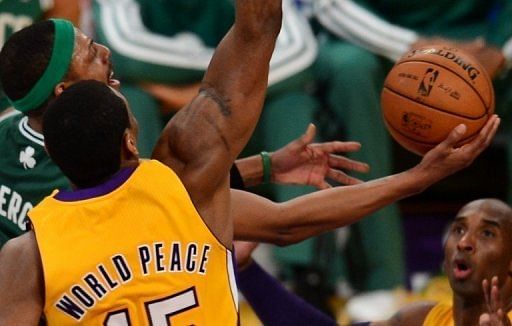Paul Pierce (L) goes to the basket against Metta World Peace (C) and Kobe Bryant of the  LA Lakers, on February 20, 2013