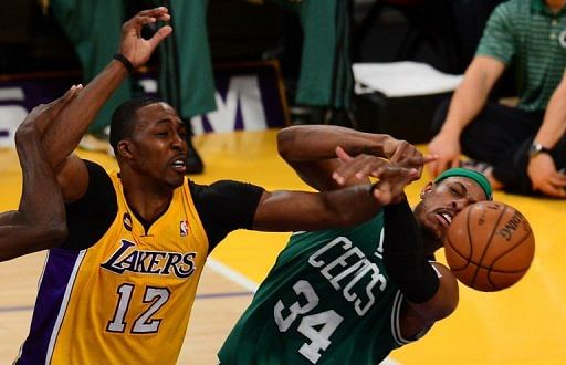 Dwight Howard (L) of the Los Angeles Lakers and Paul Pierce of the Boston Celtics grapple, on February 20, 2013
