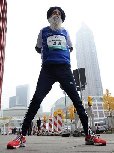 Fauja Singh stretches before the start of the Frankfurt Marathon race on October 30, 2011