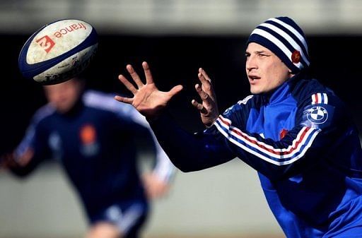 Francois Trinh-Duc eyes the ball at a training session in Marcoussis, south of Paris, on February 21, 2013
