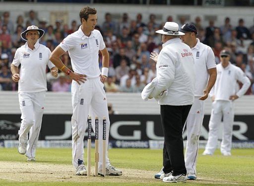 Umpire Steve Davis calls a dead ball as Steven Finn knocks off the bails while bowling at Headingley on August  2, 2012