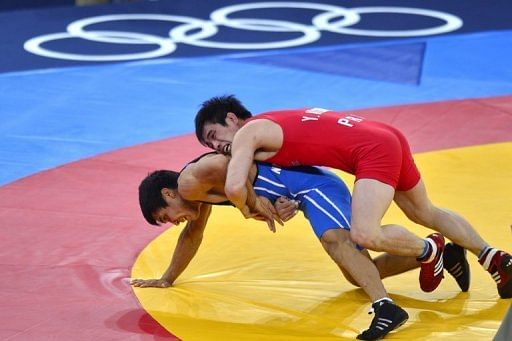 North Korea&#039;s Yang Kyong Il (right) wrestles Kazakhstan&#039;s Daulet Niyazbekov at the London Olympics on August 10, 2012