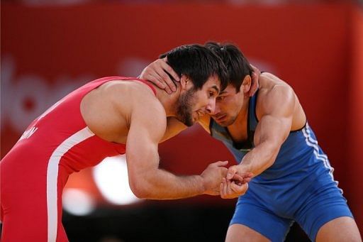Turkey&#039;s Ramazan Sahin (left) wrestles Kazakhstan&#039;s Akzhurek Tanatarov at the London Olympics on August 12, 2012
