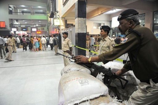 Armed officers stand vigil at the main railway station in Ahmedabad on February 21, 2013