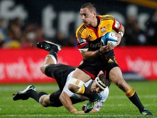 Aaron Cruden of the Waikato Chiefs is tackled by Willem Alberts of the Coastal Sharks, in Hamilton, on August 4, 2012