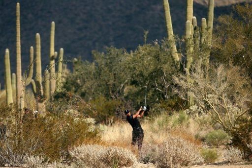 Tiger Woods hits a shot at the Ritz Carlton Golf Club course at Dove Mountain, in Marana, Arizona, on February 21, 2013