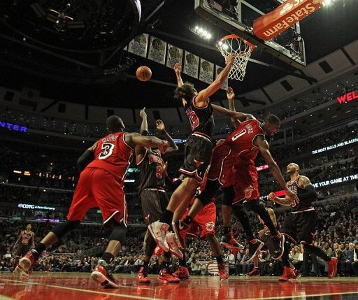 Joakim Noah #13 of the Chicago Bulls collides with Chris Bosh #1 of the Miami Heat on February 21, 2013 in Chicago
