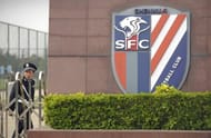 A security guard walks outside the Shanghai Shenhua Football Club in Shanghai, April 12, 2012