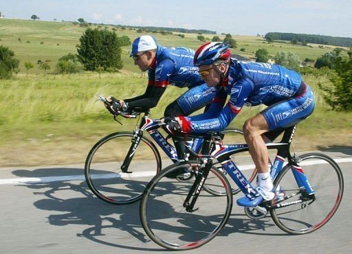 Lance Armstrong (L) and Floyd Landis ride on the eve of the prologue of the 89th Tour de France, on July 5, 2002