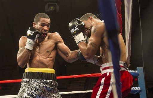 Lamont Peterson (L) works Kendall Holt against the ropes in the eighth round, on February 22, 2013