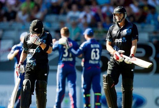 Brendon McCullum (L) hides his face as team-mate Kane Williamson walks off after being caught, on February 23, 2013