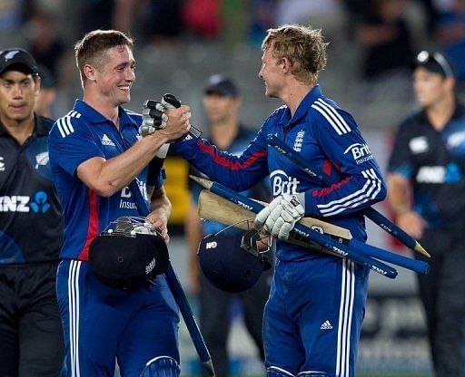 Chris Woakes (L) and Joe Root celebrate victory in the final one-day international in Auckland on February 23, 2013