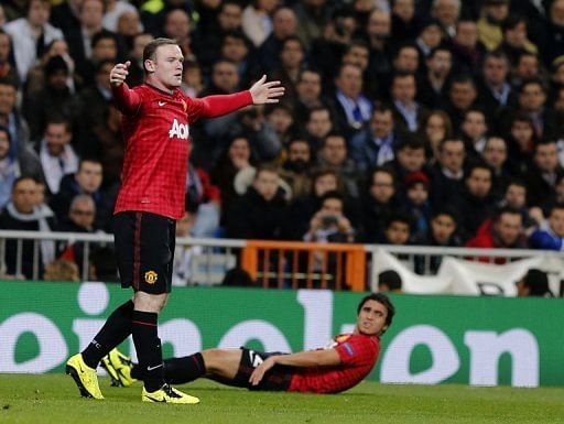 Wayne Rooney (L) looks for a foul during the Champions League game at Real Madrid on February 13, 2013