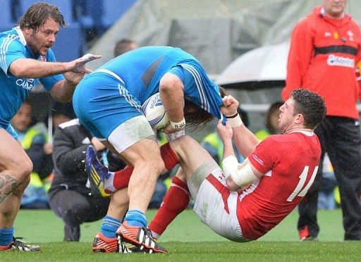 Alex Cuthbert (R) of Wales tackles Italian Martin Castrogiovanni (L) on February 23, 2013 in Rome