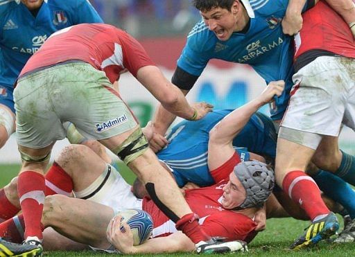 Jonathan Davies (C) of Wales is tackled at the Olympic Stadium on February 23, 2013 in Rome