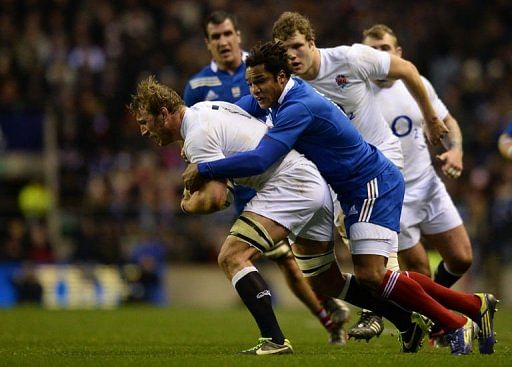 England&#039;s Chris Robshaw (L) gets tackled by France&#039;s Benjamin Fall (R) at Twickenham Stadium on February 23, 2013