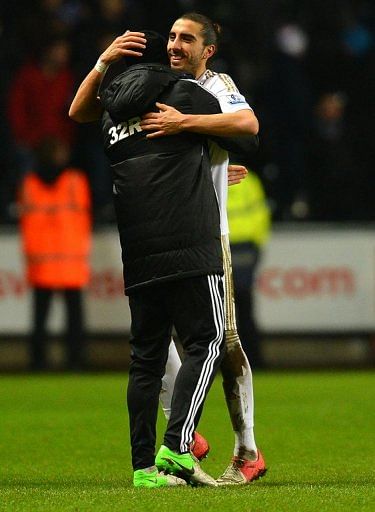 Swansea defender Chico Flores (R) celebrates at the final whistle of the League Cup semi-final second leg against Chelsea