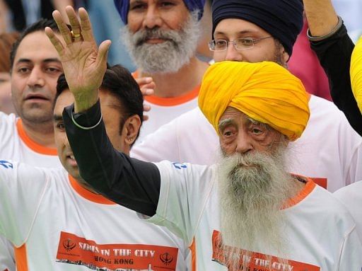 Fauja Singh crosses the finish line in the 10km event as part of the Hong Kong Marathon on February 24, 2013