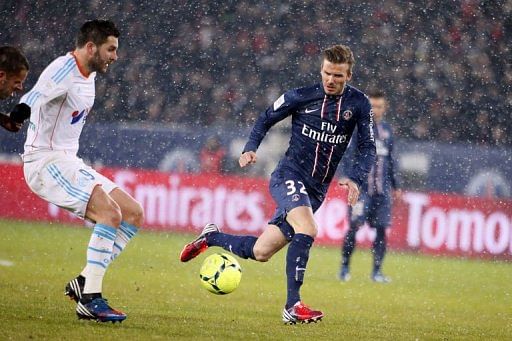 Paris Saint-Germain David Beckham (R) vies with Marseille&#039;s Andre Pierre Gignac on February 24, 2013 in Paris