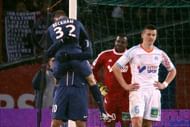 PSG's David Beckham jumps on teammate Zlatan Ibrahimovic on February 24, 2013 in Paris