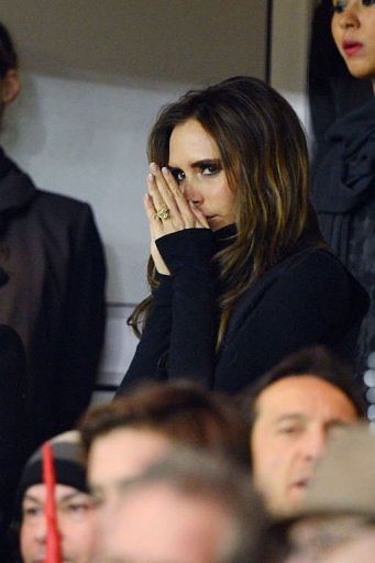 Victoria Beckham (C) is pictured in the stands on February 24, 2013 at the Parc des Princes