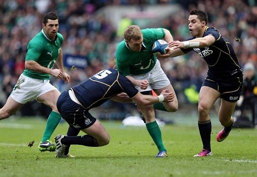Ireland&#039;s wing Keith Earls (C) is tackled by Scotland&#039;s full back Stuart Hogg (L) in Edinburgh on February 24, 2013