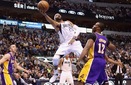 Vince Carter of the Dallas Mavericks is fouled by Dwight Howard of the Los Angeles Lakers on February 24, 2013 in Dallas