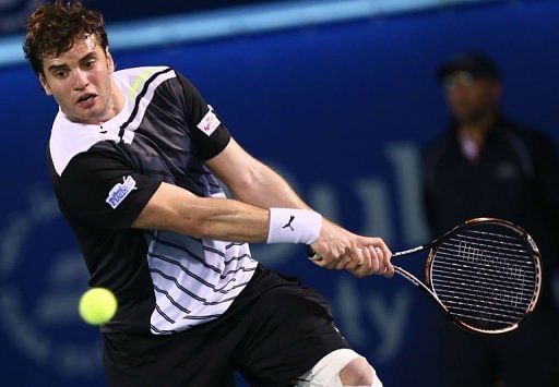 Malek Jaziri returns the ball to Roger Federer in Dubai on February 25, 2013