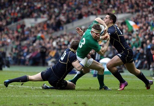 Ireland&#039;s Brian O&#039;Driscoll is tackled by Scotland&#039;s Sean Lamont and Sean Maitland, in Edinburgh, on February 24, 2013